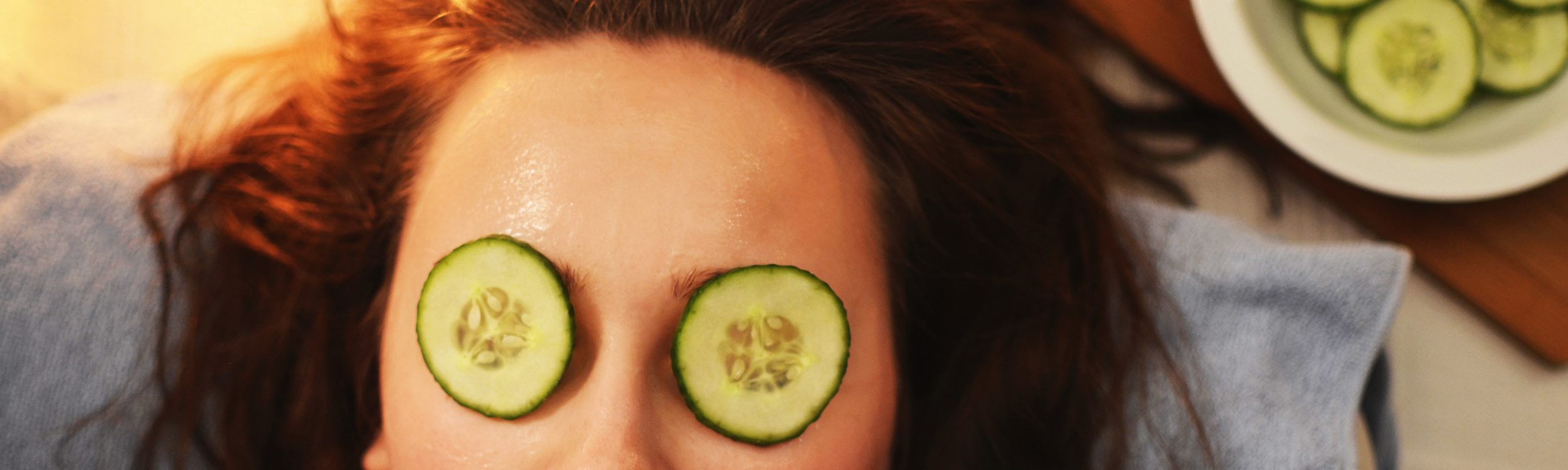 woman with cucumbers slices on her eyelids